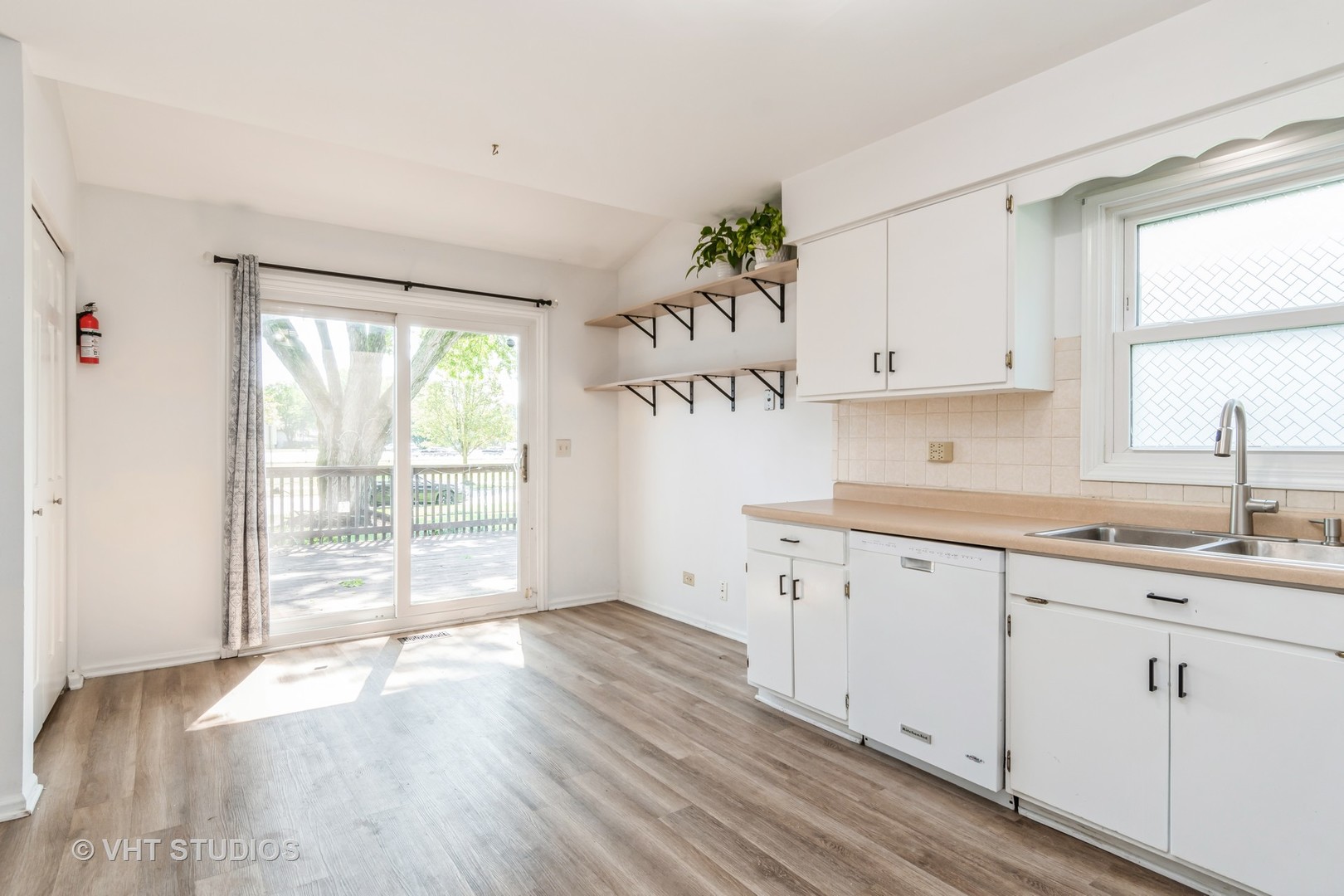 76 West Bailey Road Naperville, IL 60565 - Photo 5 of 20 a kitchen with granite countertop a white sink and window