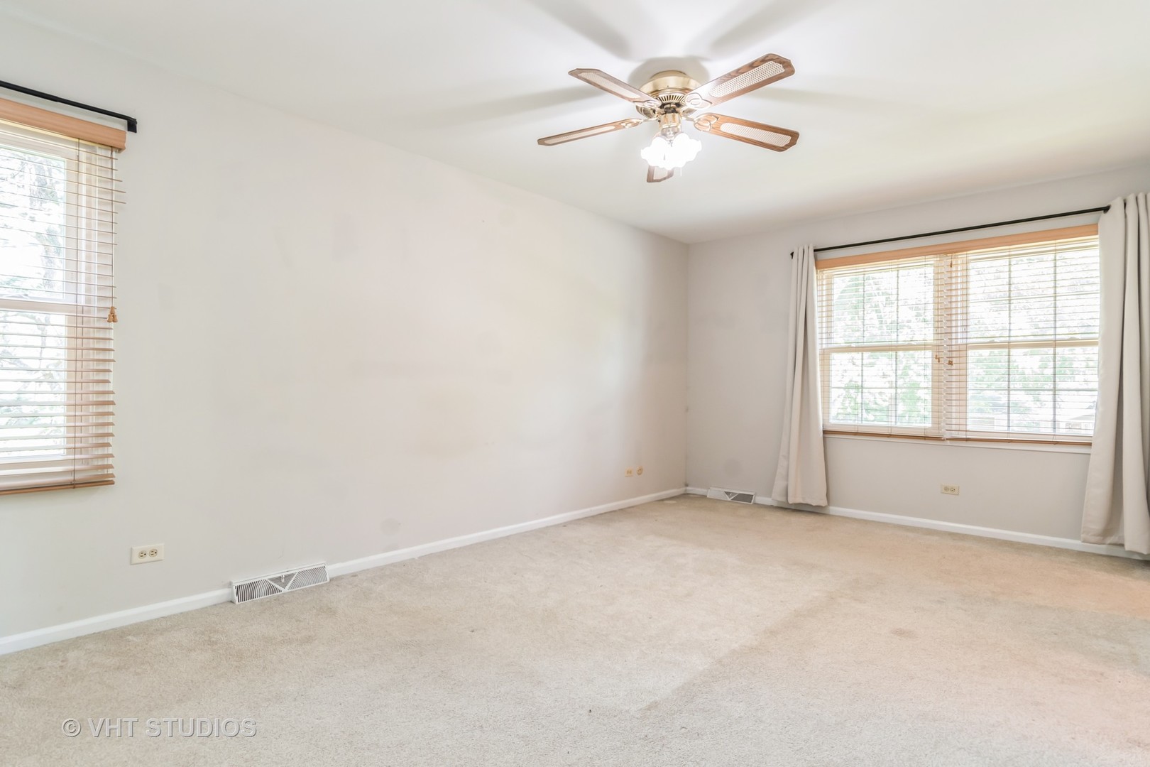 76 West Bailey Road Naperville, IL 60565 - Photo 8 of 20 an empty room with chandelier fan and windows