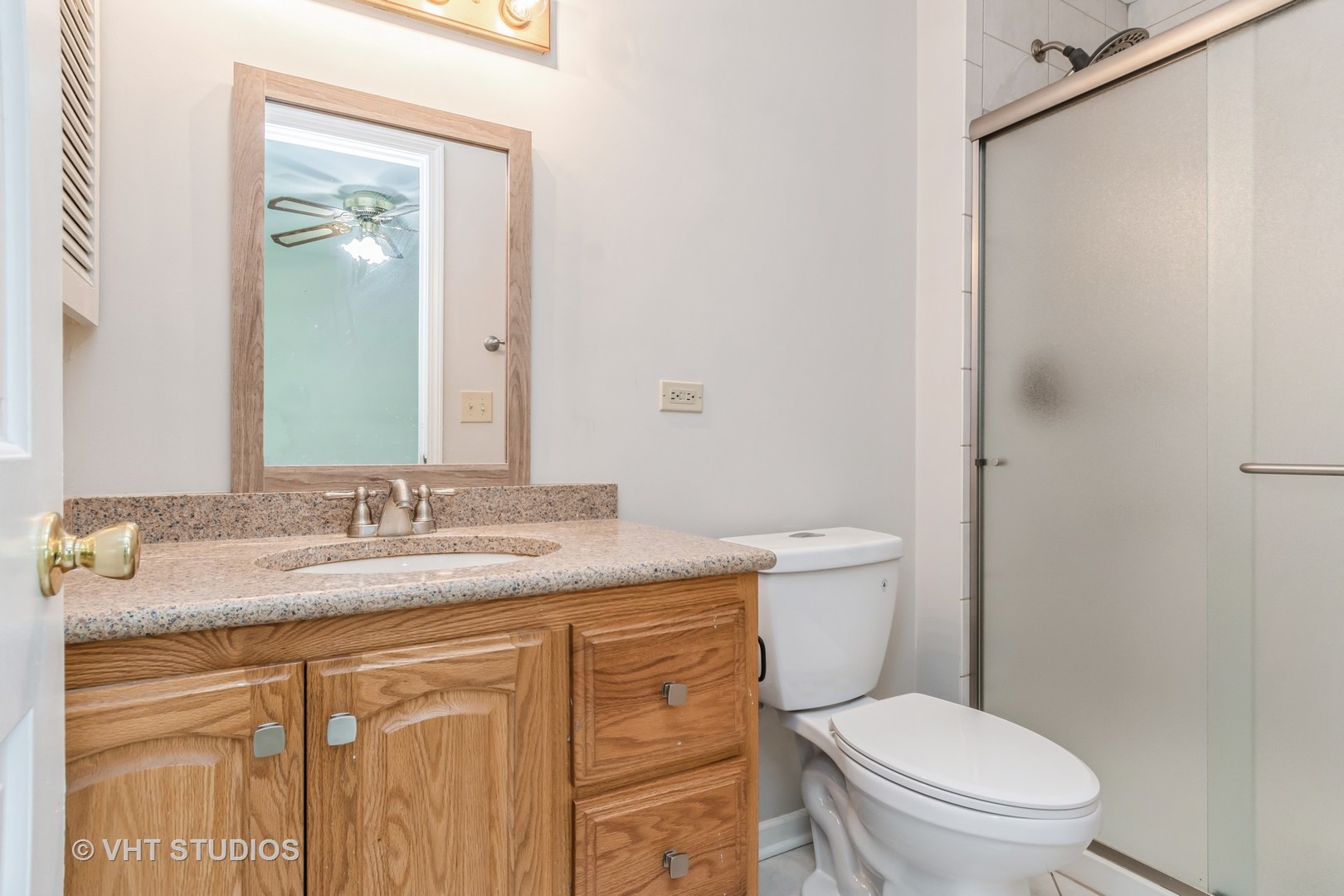 76 West Bailey Road Naperville, IL 60565 - Photo 9 of 20 a bathroom with a granite countertop toilet sink and mirror