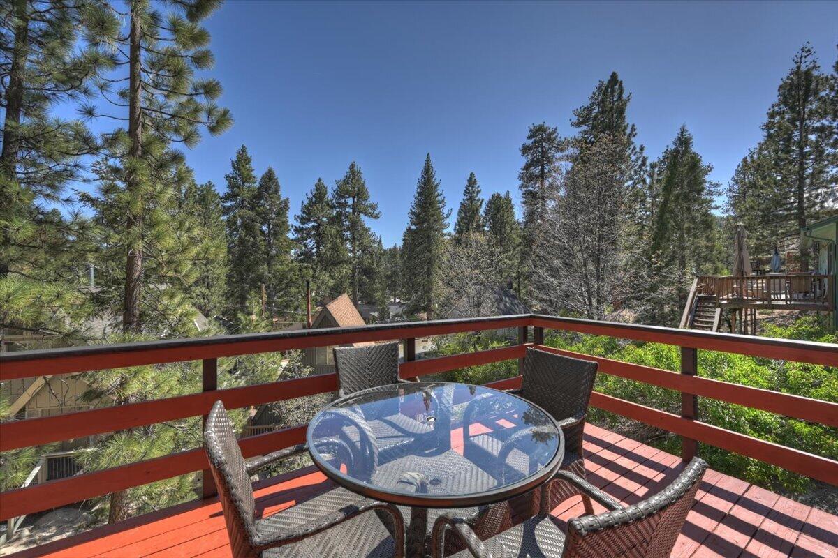 39187 Arapahoe Road Fawnskin, CA 92333 - Photo 26 of 33 a view of a chairs and table on the deck