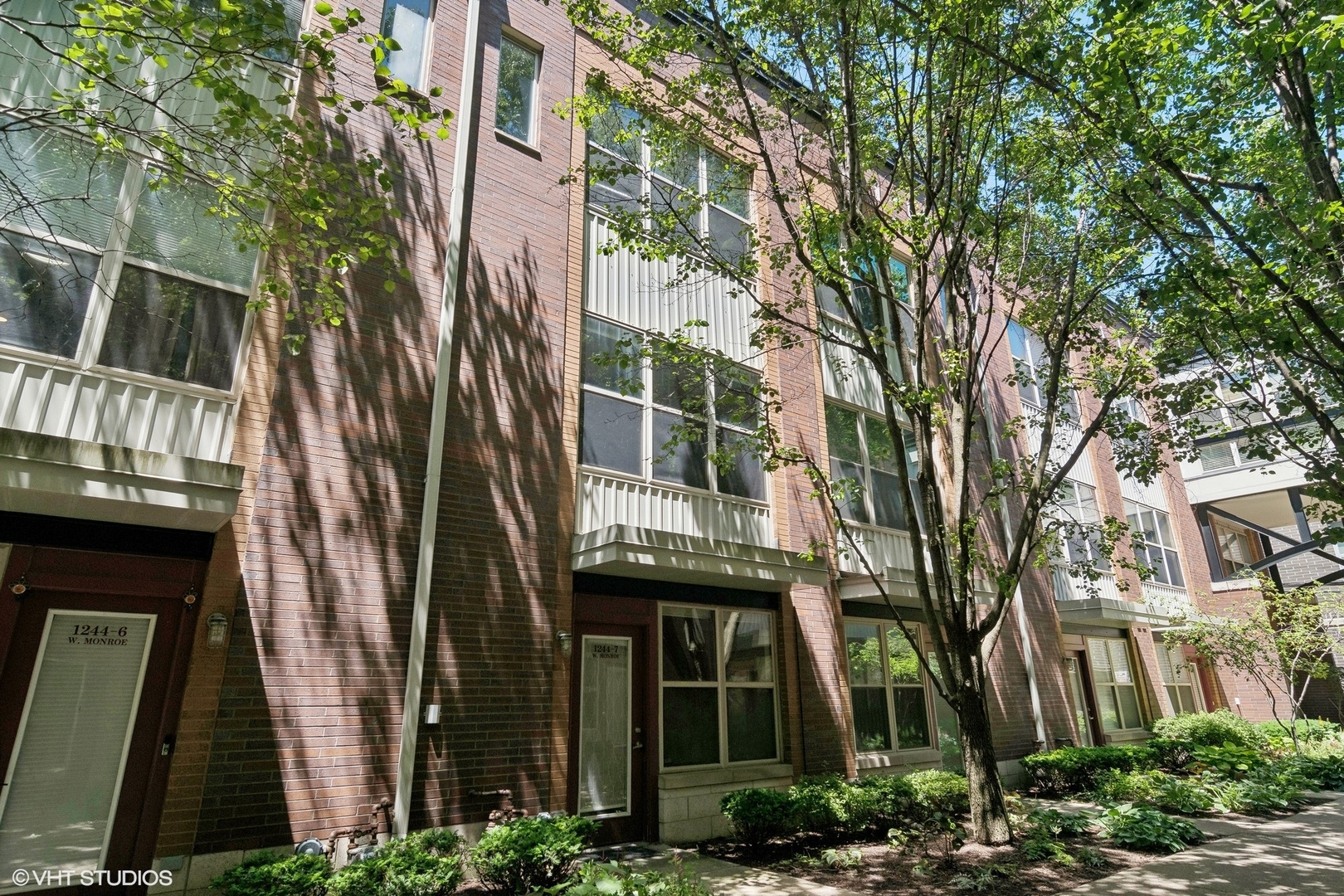 a front view of a multi story building with yard
