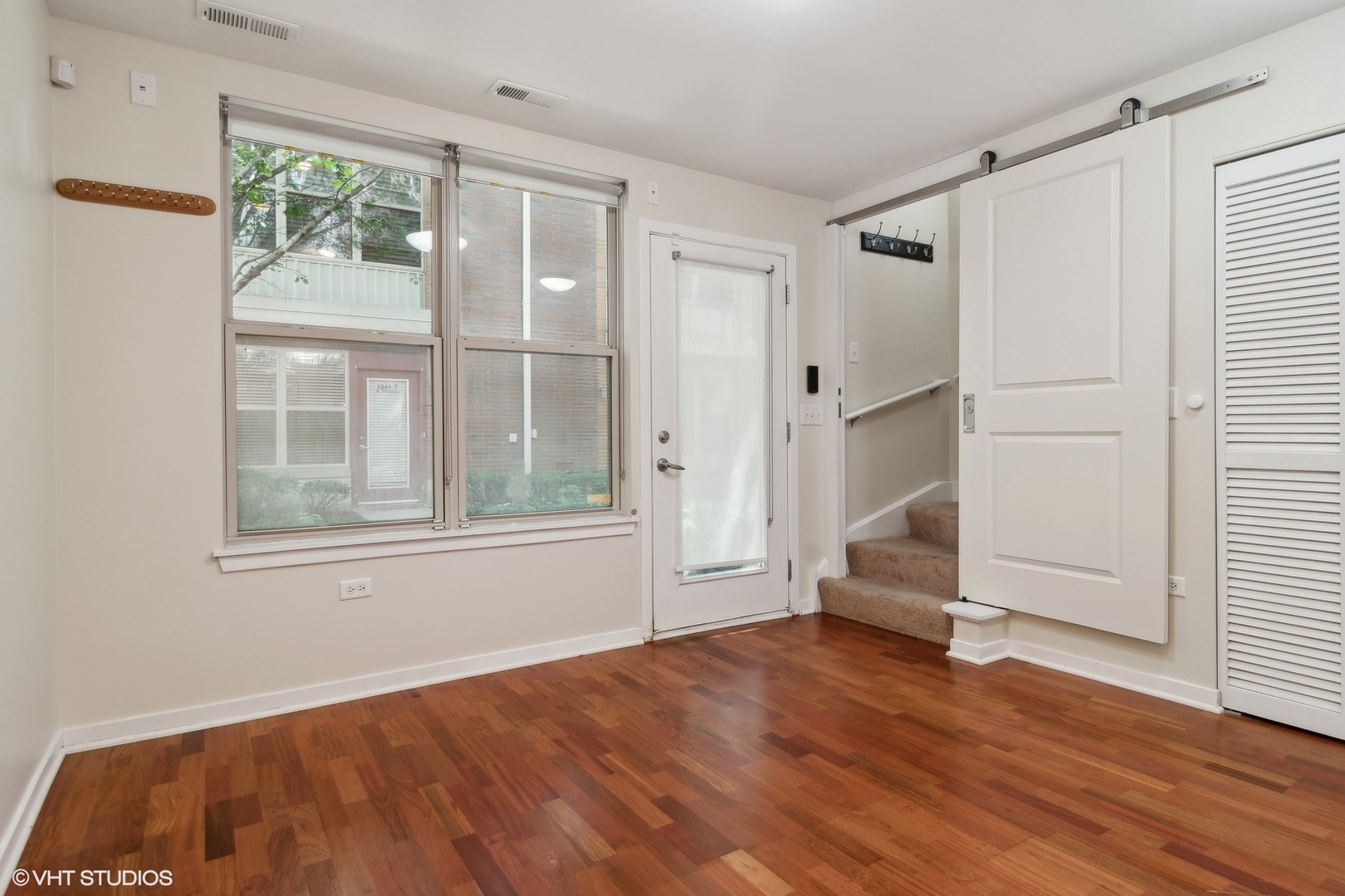 1244 West Monroe Street, Unit 7 Chicago, IL 60607 - Photo 15 of 18 an empty room with wooden floor and windows