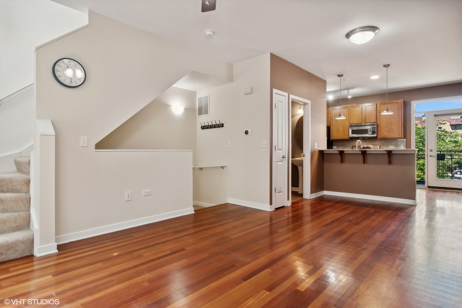 1244 West Monroe Street, Unit 7 Chicago, IL 60607 - Photo 3 of 18 an empty room with wooden floor and a kitchen view