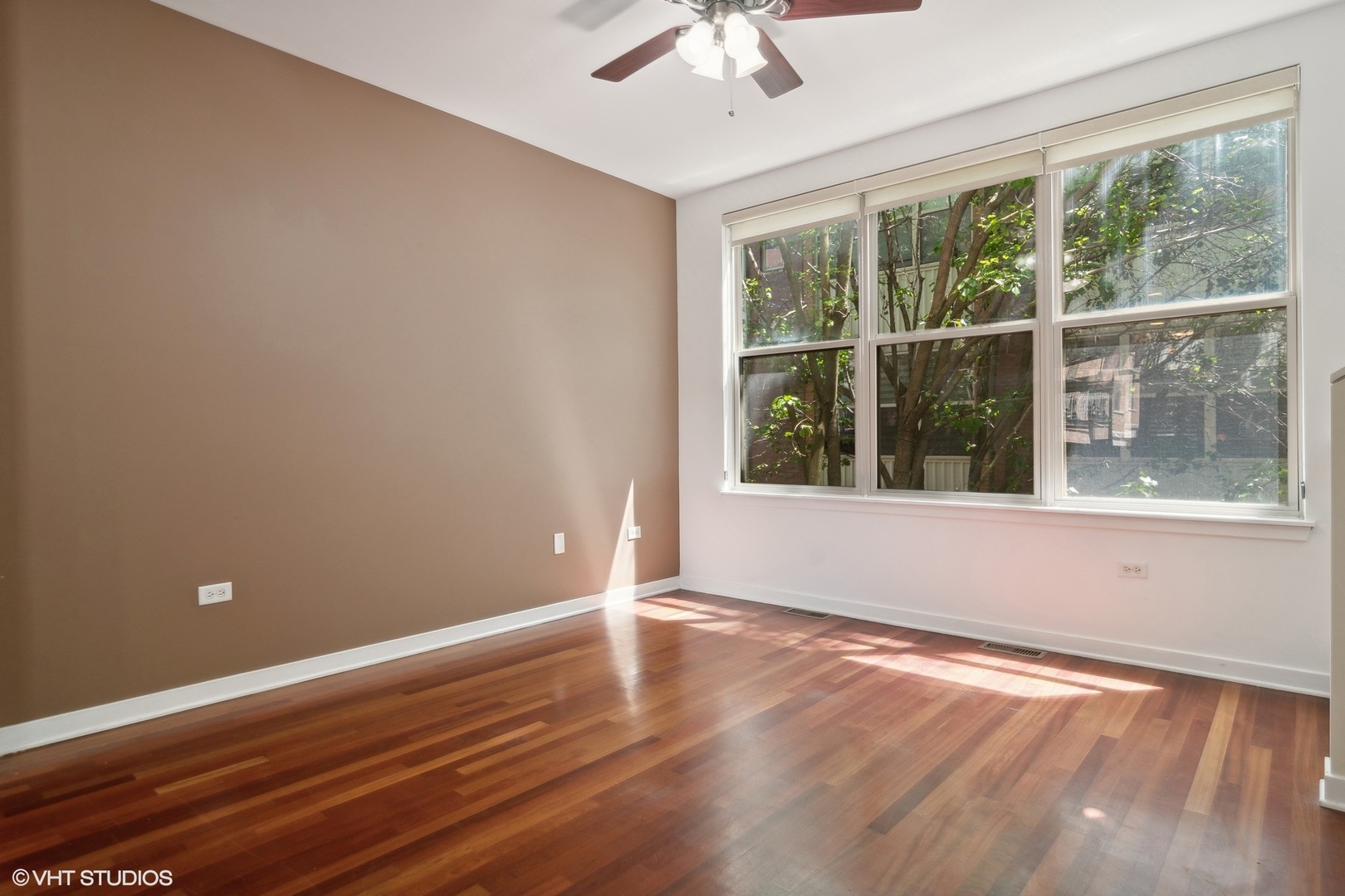 1244 West Monroe Street, Unit 7 Chicago, IL 60607 - Photo 5 of 18 a view of an empty room with wooden floor and a window