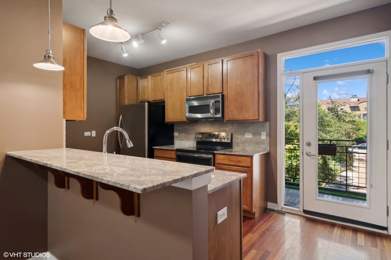 1244 West Monroe Street, Unit 7 Chicago, IL 60607 - Photo 8 of 18 a kitchen with a stove a sink a microwave a refrigerator and cabinets