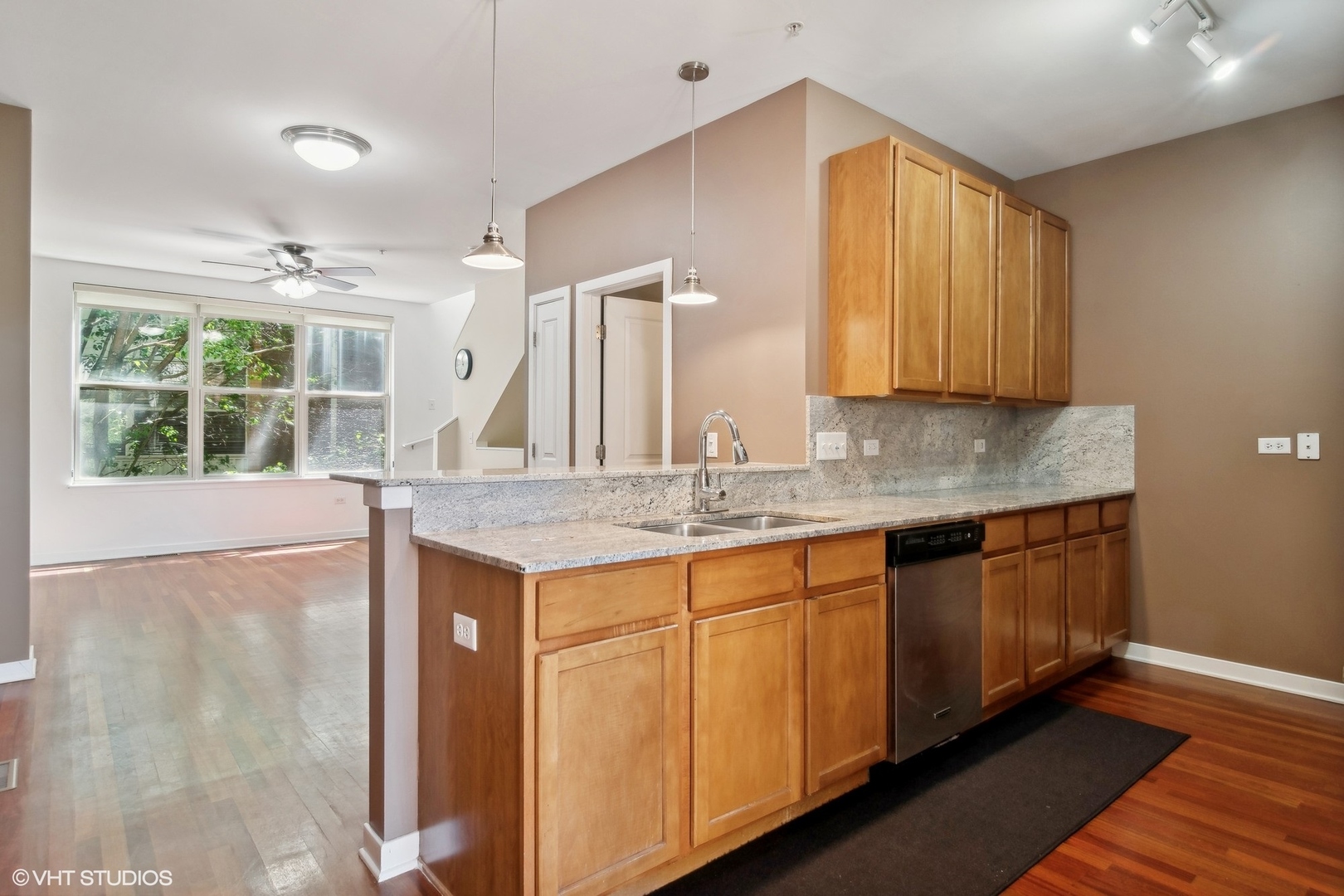1244 West Monroe Street, Unit 7 Chicago, IL 60607 - Photo 10 of 18 a kitchen with granite countertop a sink and a window