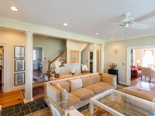 a very nice looking room with many windows and furniture