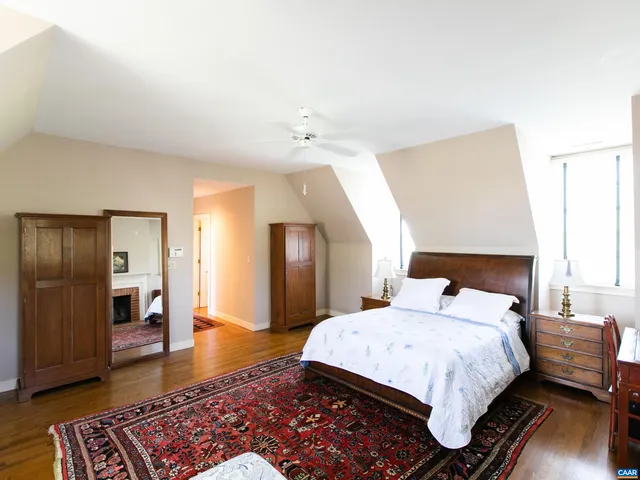 a bedroom with furniture and a fireplace