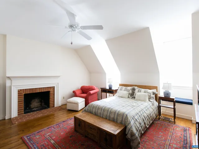 a bedroom with furniture and a wooden floor