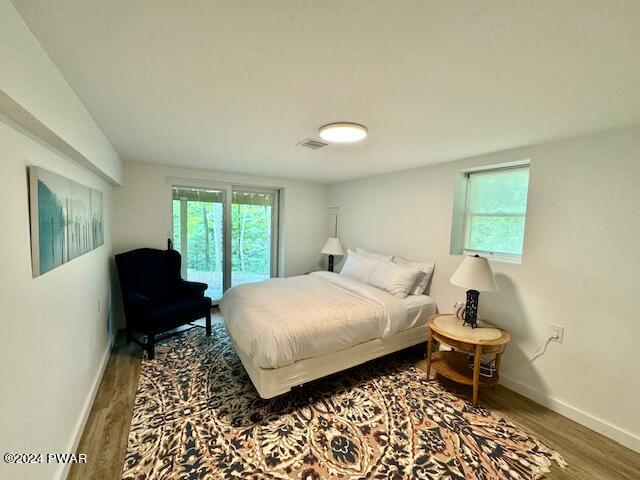 3067 Northgate Road Lake Ariel, PA 18436 - Photo 55 of 79 a bedroom with a bed and wooden floor