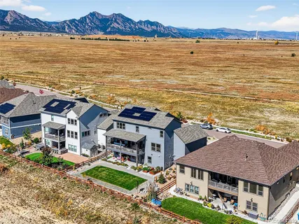 a aerial view of a house next to a lake with a large mountain view