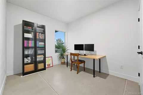 a living room with furniture and a bookshelf
