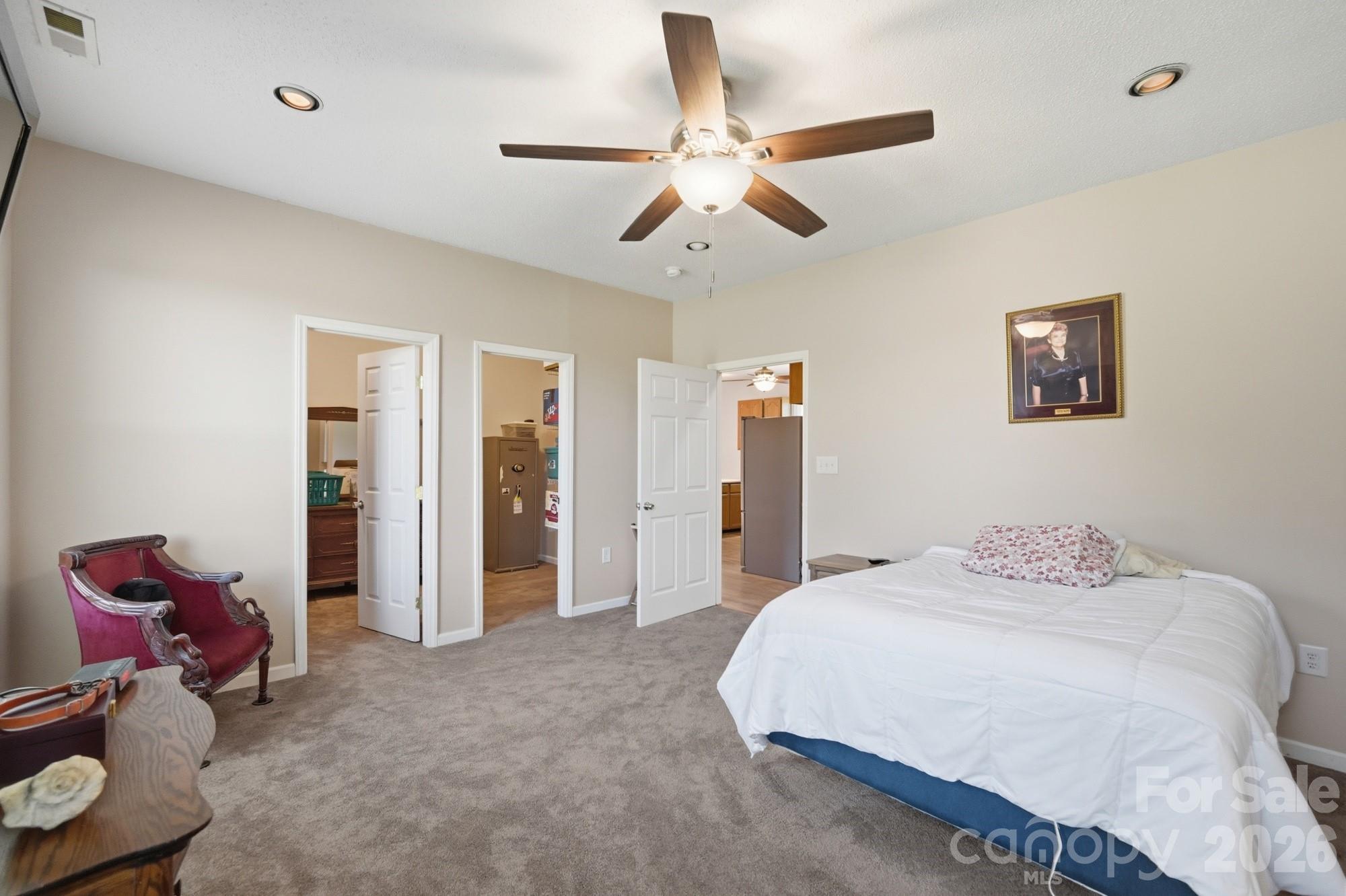 4415 Old Monroe Marshville Road Wingate, NC 28174 - Photo 10 of 28 a bedroom with a bed and a chandelier