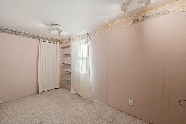 a view of a room with closet and windows