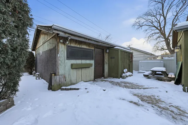 a backyard of a house with fire pit and trees
