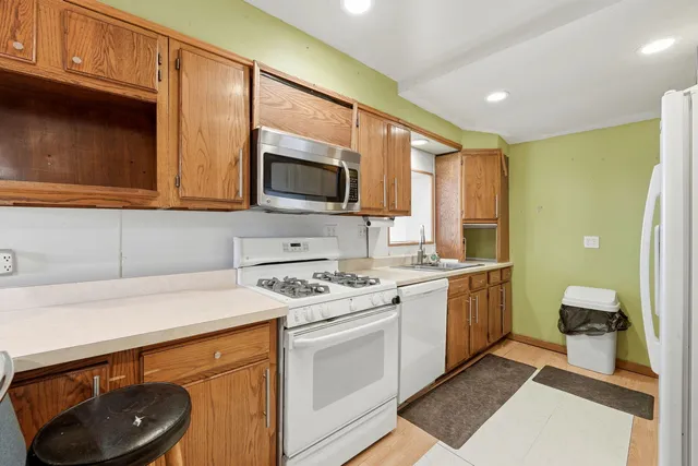 a kitchen with a sink a stove and cabinets
