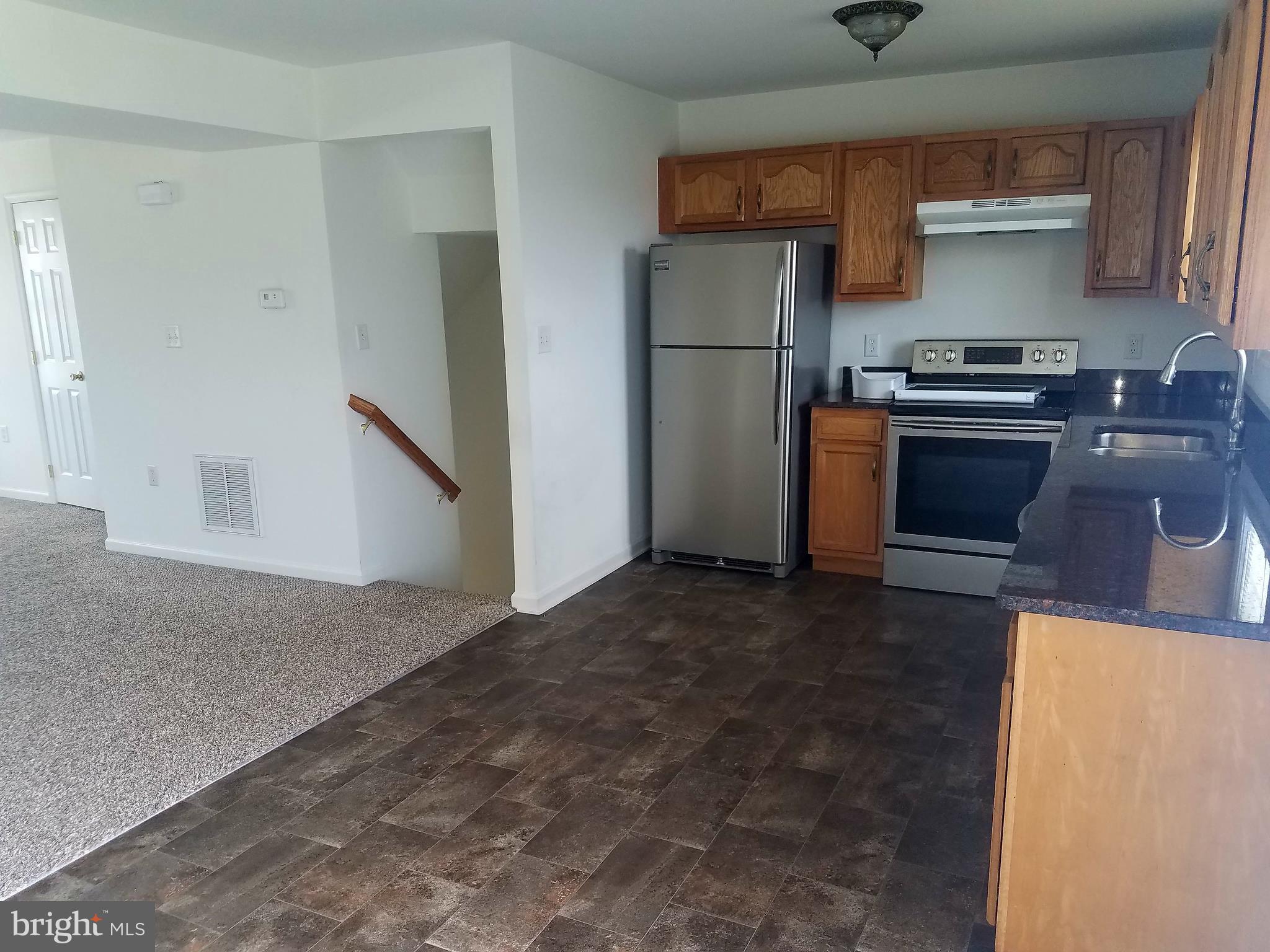 79 Fuzzy Tail Drive Ranson, WV 25438 - Photo 4 of 18 a kitchen with a refrigerator and a stove