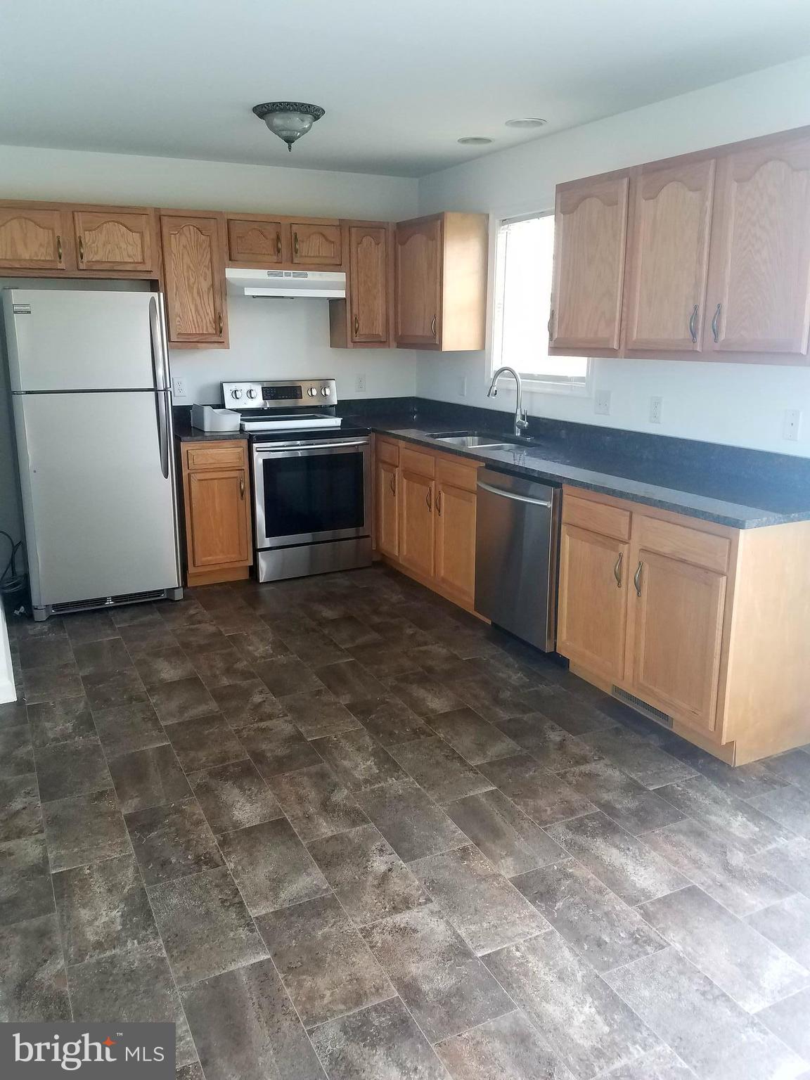 79 Fuzzy Tail Drive Ranson, WV 25438 - Photo 5 of 18 a kitchen with granite countertop a sink stainless steel appliances and cabinets
