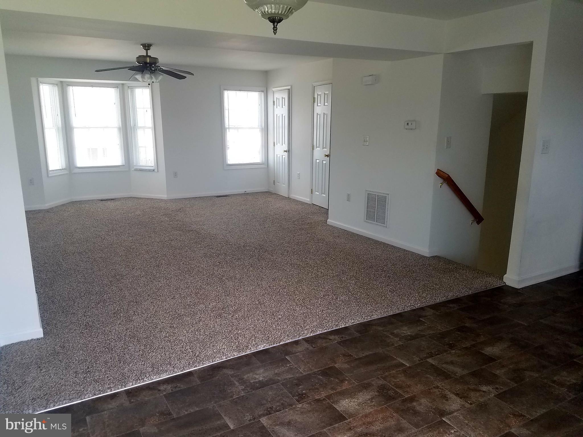 79 Fuzzy Tail Drive Ranson, WV 25438 - Photo 9 of 18 an empty room with windows and stairs