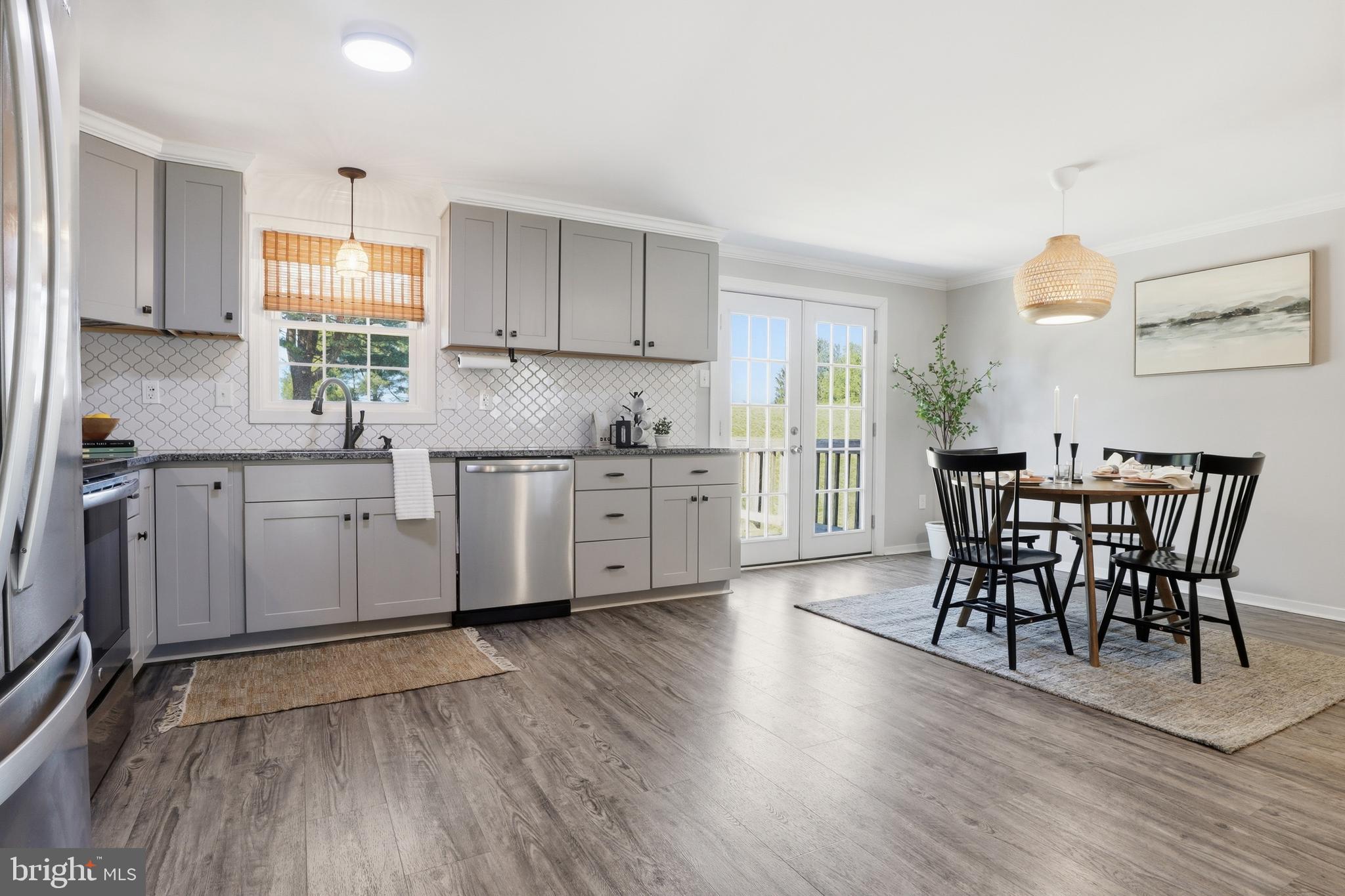 339 Lay Road Delta, PA 17314 - Photo 11 of 60 a kitchen with stainless steel appliances a dining table chairs and wooden floor