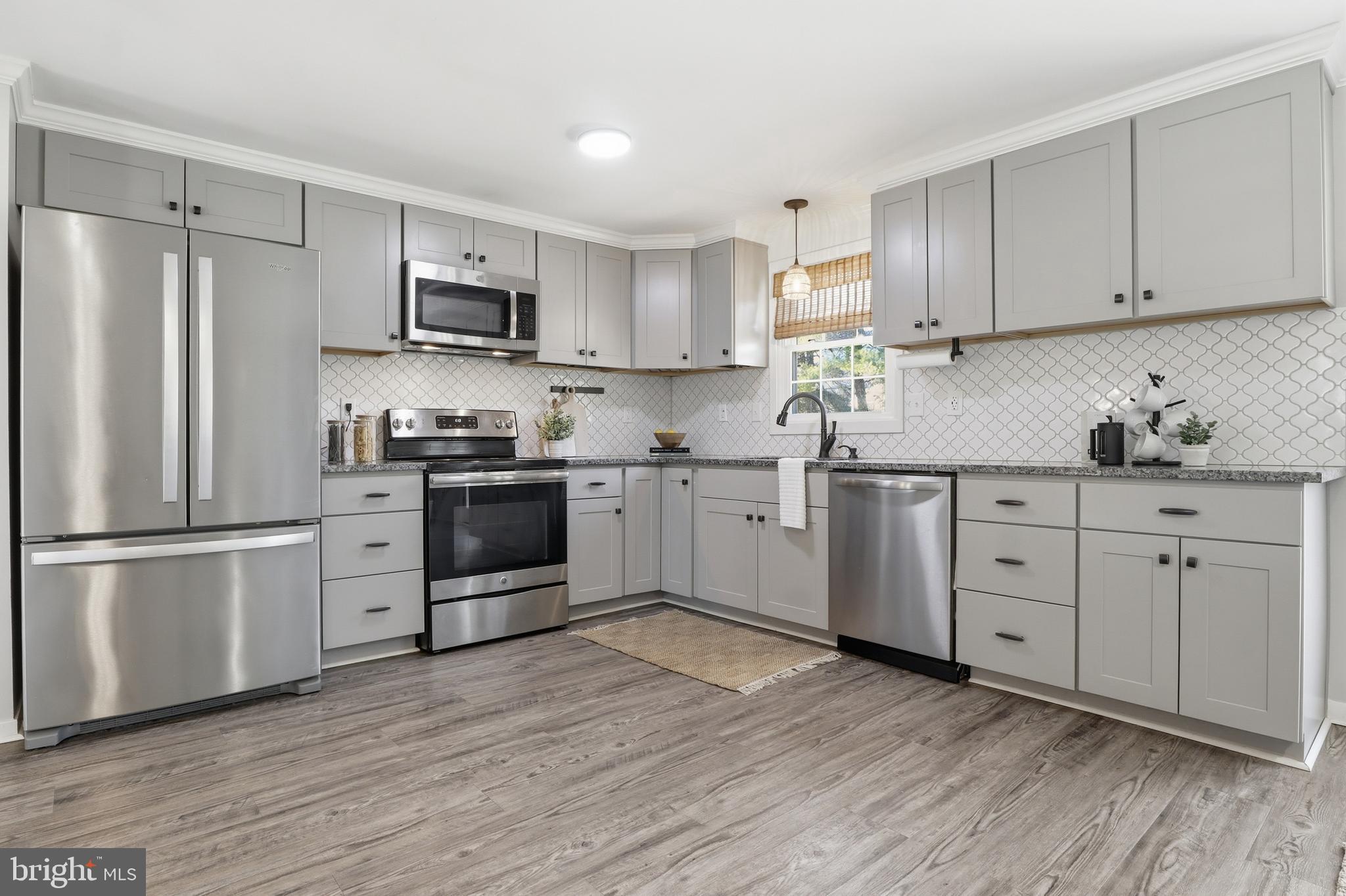 339 Lay Road Delta, PA 17314 - Photo 12 of 60 a kitchen with white cabinets stainless steel appliances and a window
