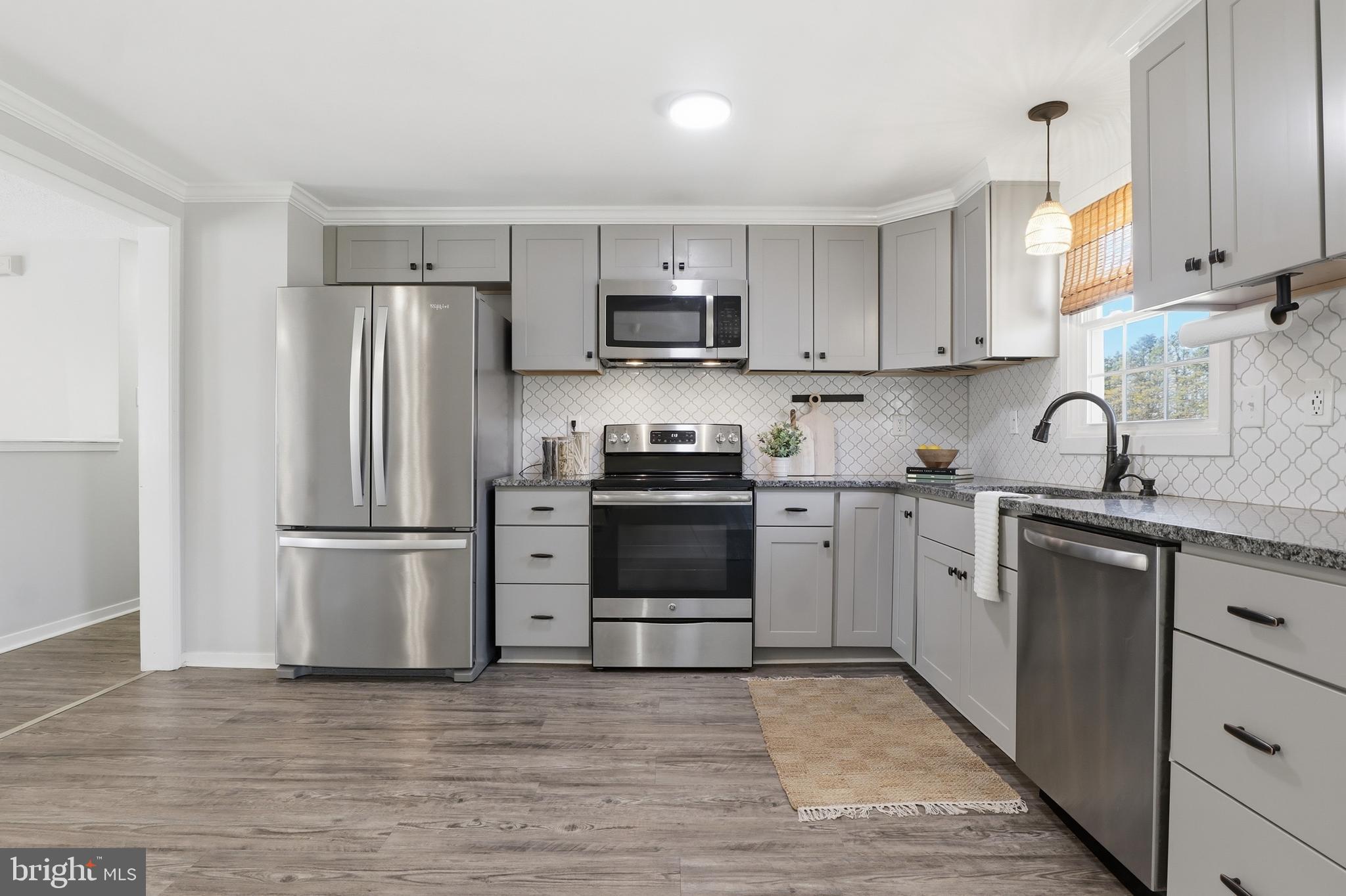 339 Lay Road Delta, PA 17314 - Photo 13 of 60 a kitchen with a refrigerator sink and white cabinets
