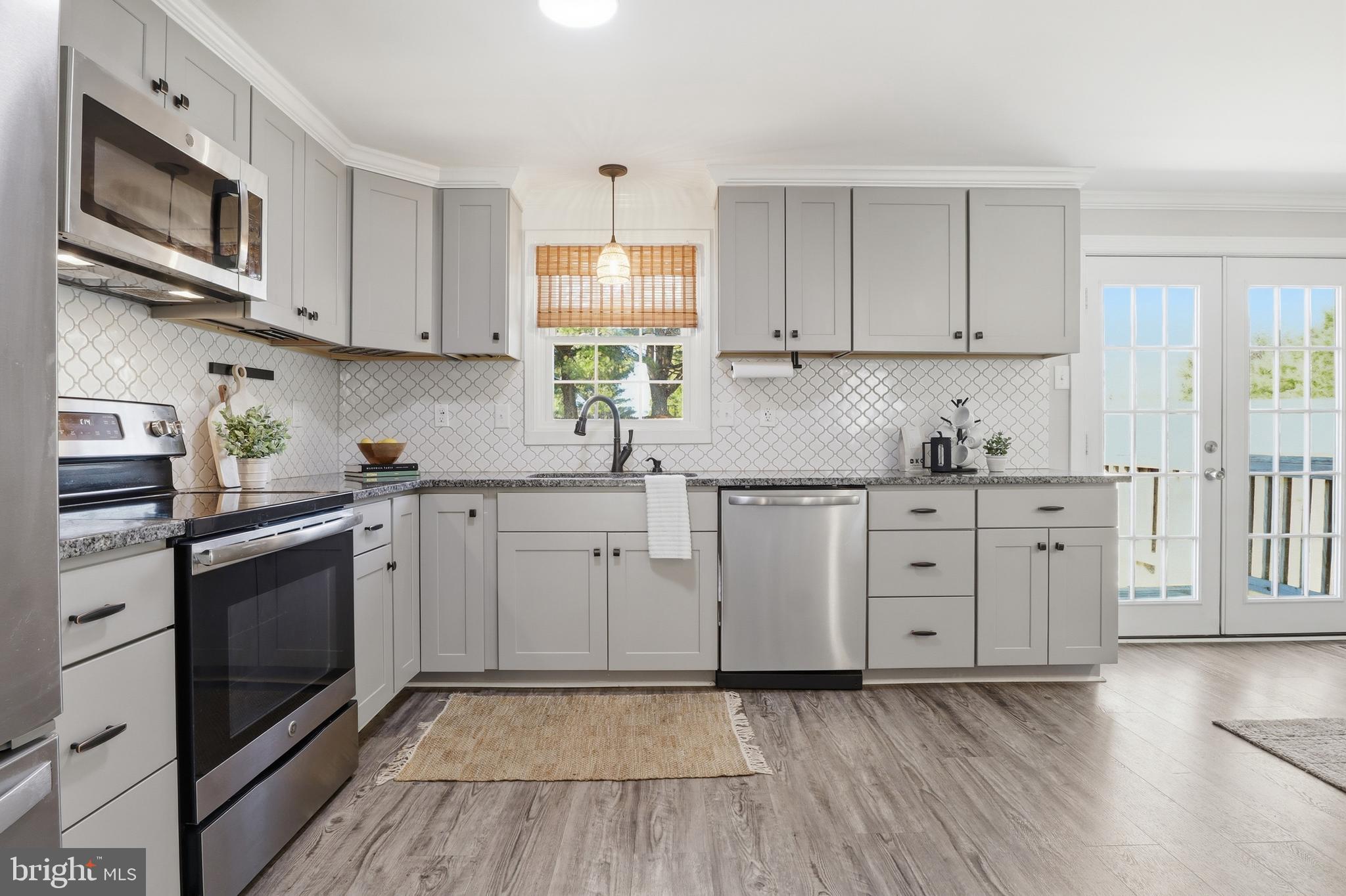 339 Lay Road Delta, PA 17314 - Photo 14 of 60 a kitchen with stainless steel appliances granite countertop a stove a sink and a microwave