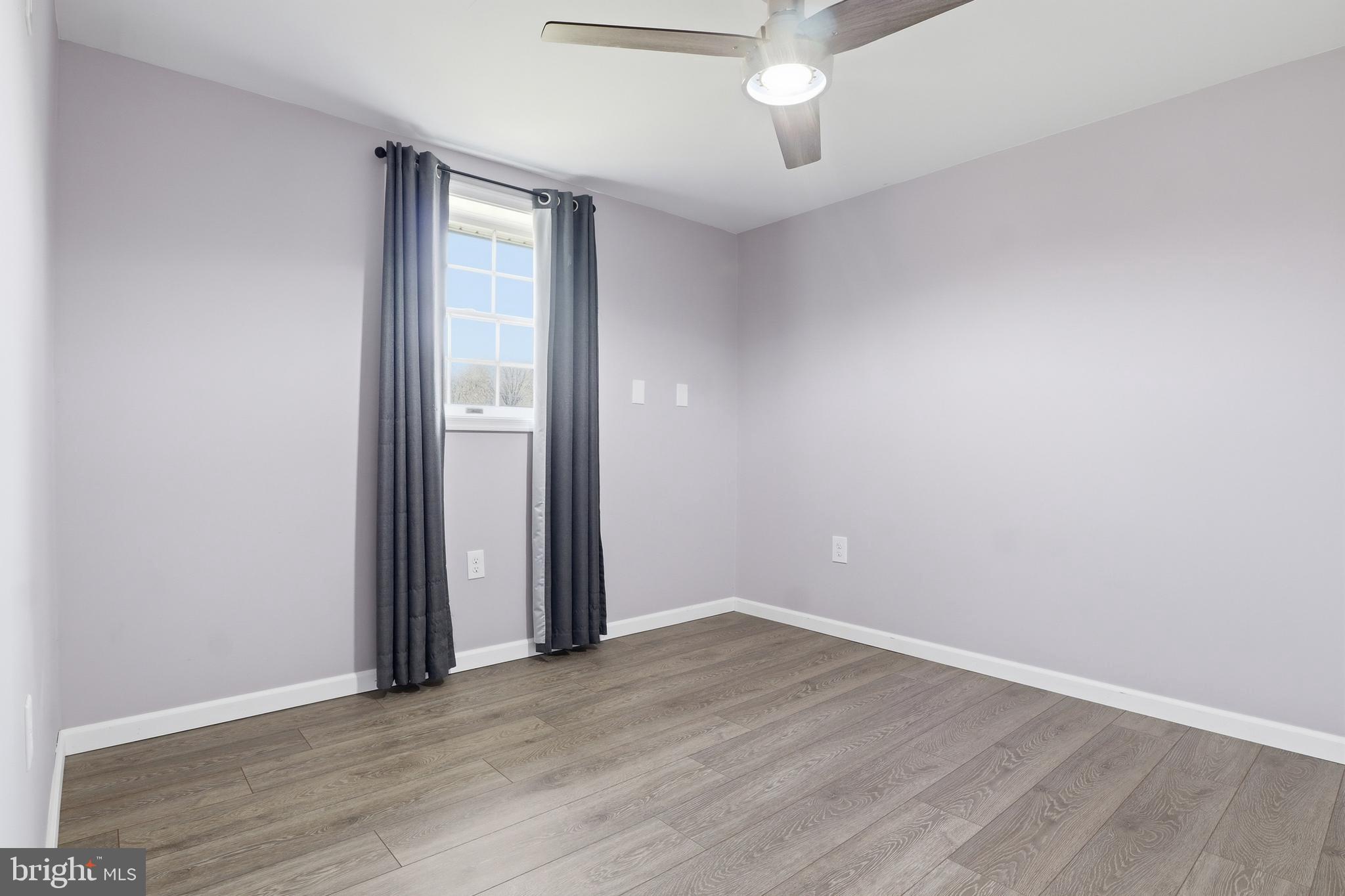 339 Lay Road Delta, PA 17314 - Photo 32 of 60 an empty room with wooden floor and a window