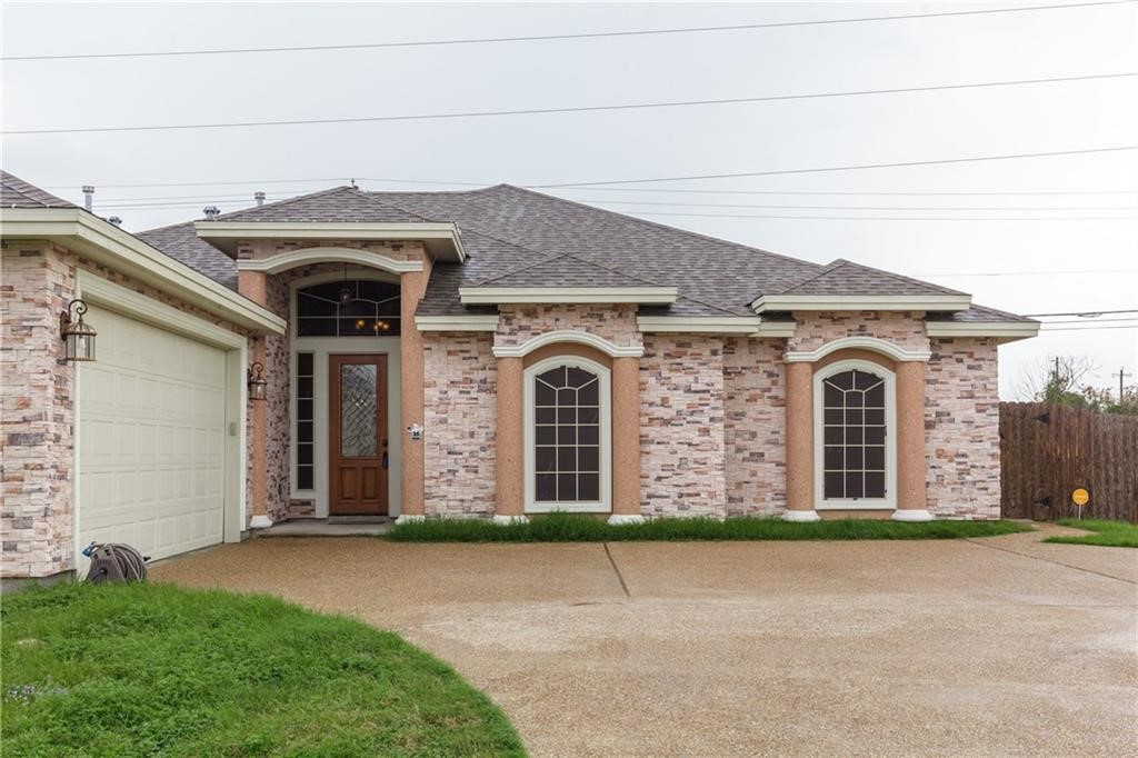 1306 Keenland Road Corpus Christi, TX 78418 - Photo 1 of 26 a front view of a house with yard