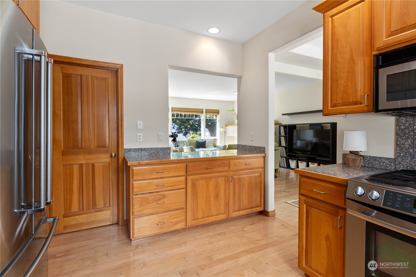 2030 Rucker Avenue, Unit 3 Everett, WA 98201 - Photo 14 of 40 a kitchen with stainless steel appliances granite countertop a refrigerator and a stove top oven