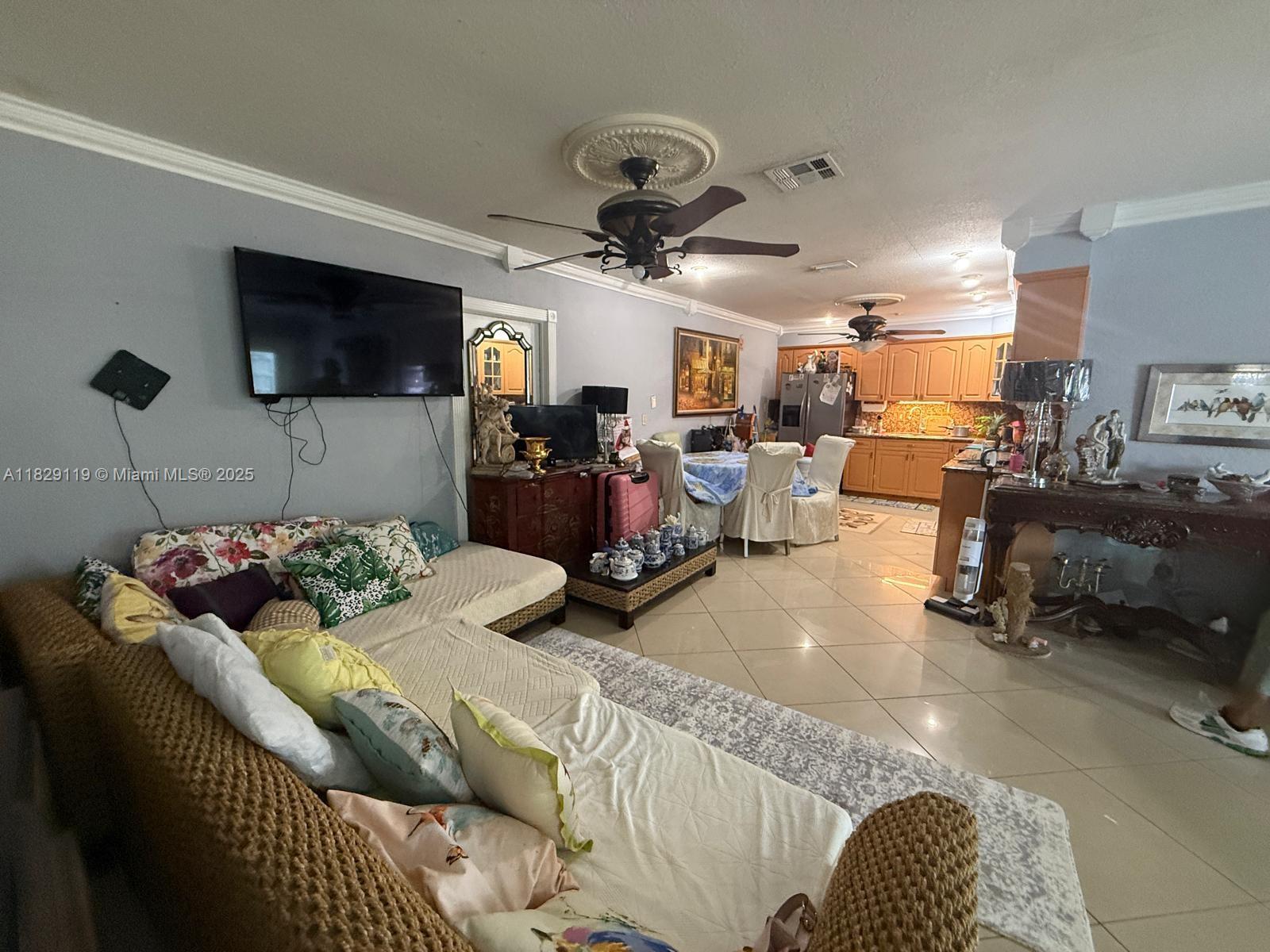 7900 Southwest 21st Terrace Miami, FL 33155 - Photo 3 of 19 a living room with furniture and a flat screen tv