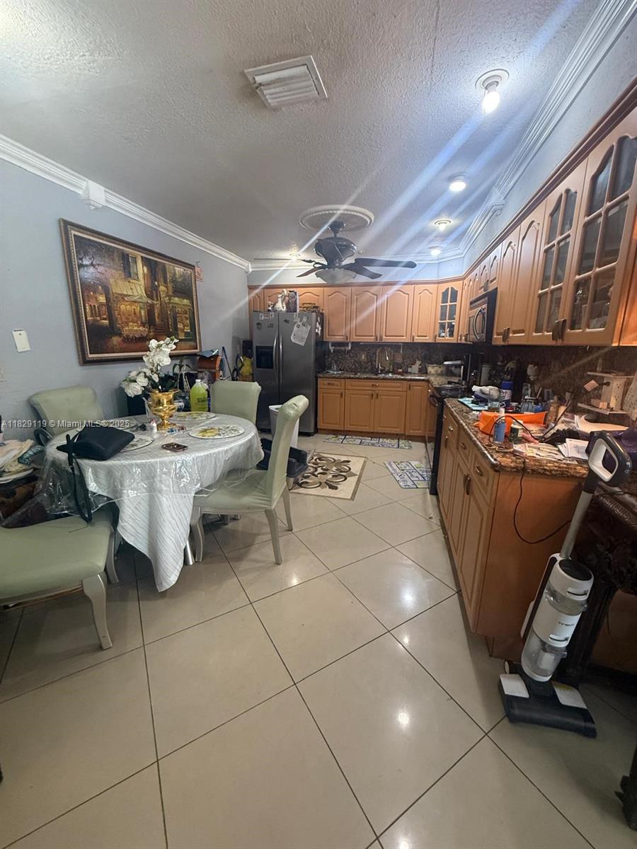 7900 Southwest 21st Terrace Miami, FL 33155 - Photo 4 of 19 a room with stainless steel appliances lots of furniture and a view of kitchen