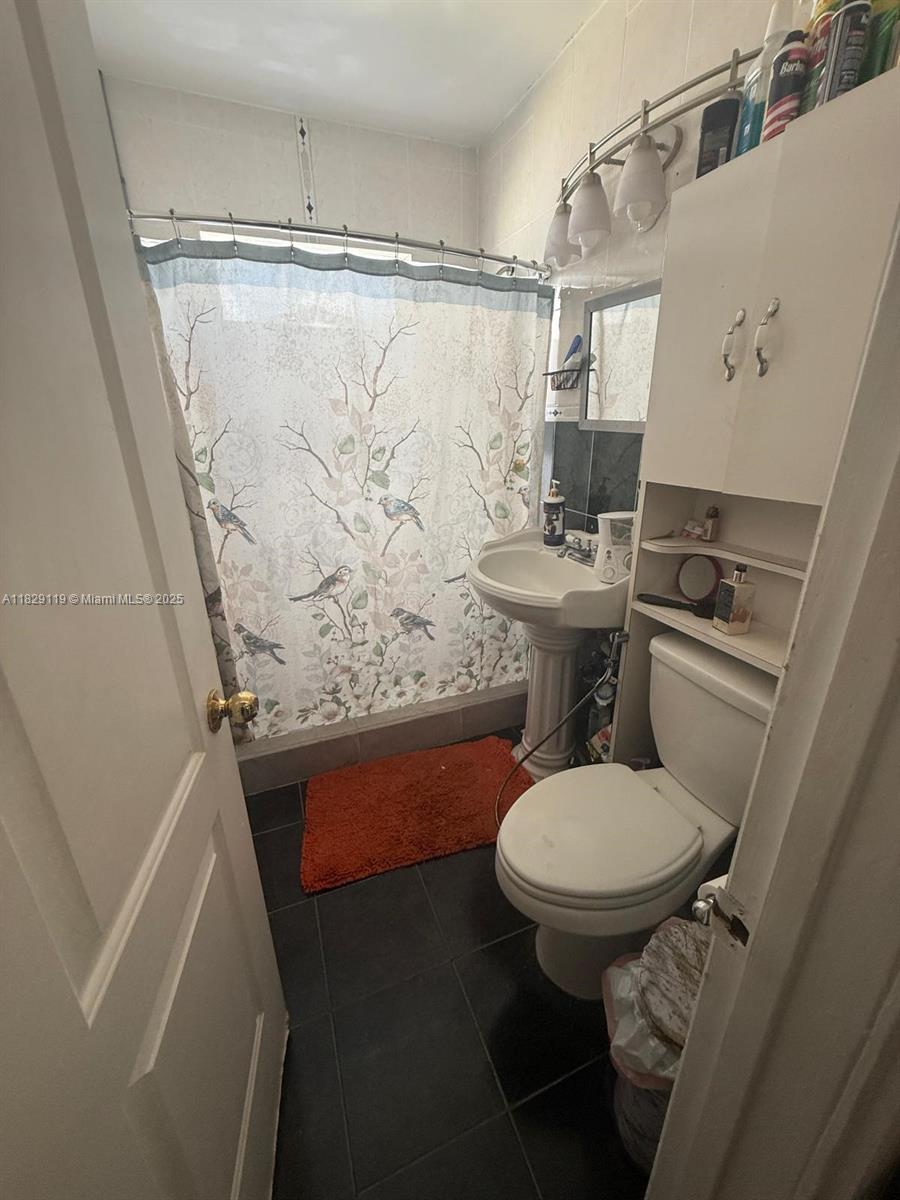 7900 Southwest 21st Terrace Miami, FL 33155 - Photo 5 of 19 a bathroom with a sink toilet and shower