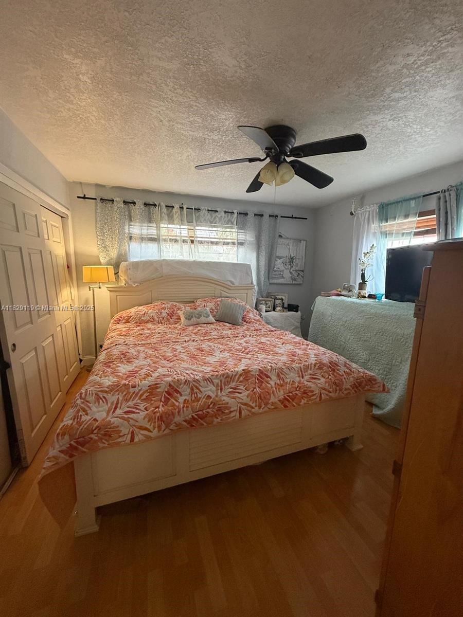 7900 Southwest 21st Terrace Miami, FL 33155 - Photo 6 of 19 a bed sitting in a bedroom next to a larger window