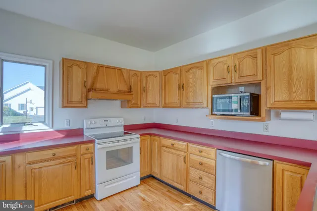 a spacious bathroom with a granite countertop sink and a mirror
