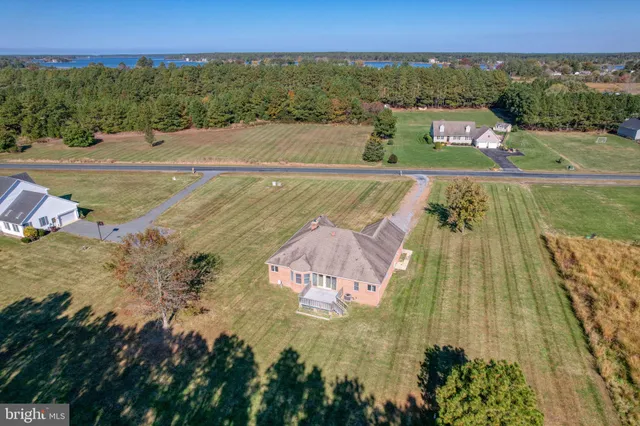 an aerial view of a house with a ocean view