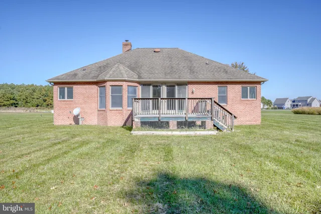 a view of a brick house with large windows