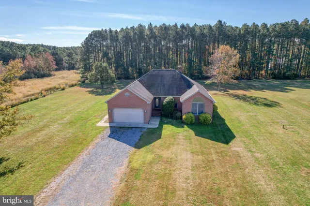 a house with green field in front of it