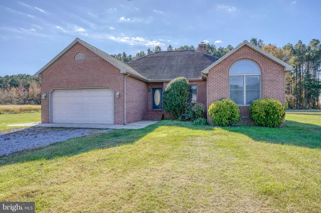 a view of a house with a yard and garage