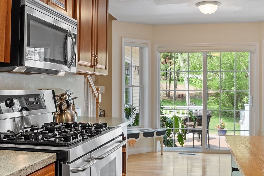2 Gullane Road Hooksett, NH 03106 - Photo 11 of 27 a kitchen with a stove and a wooden floor