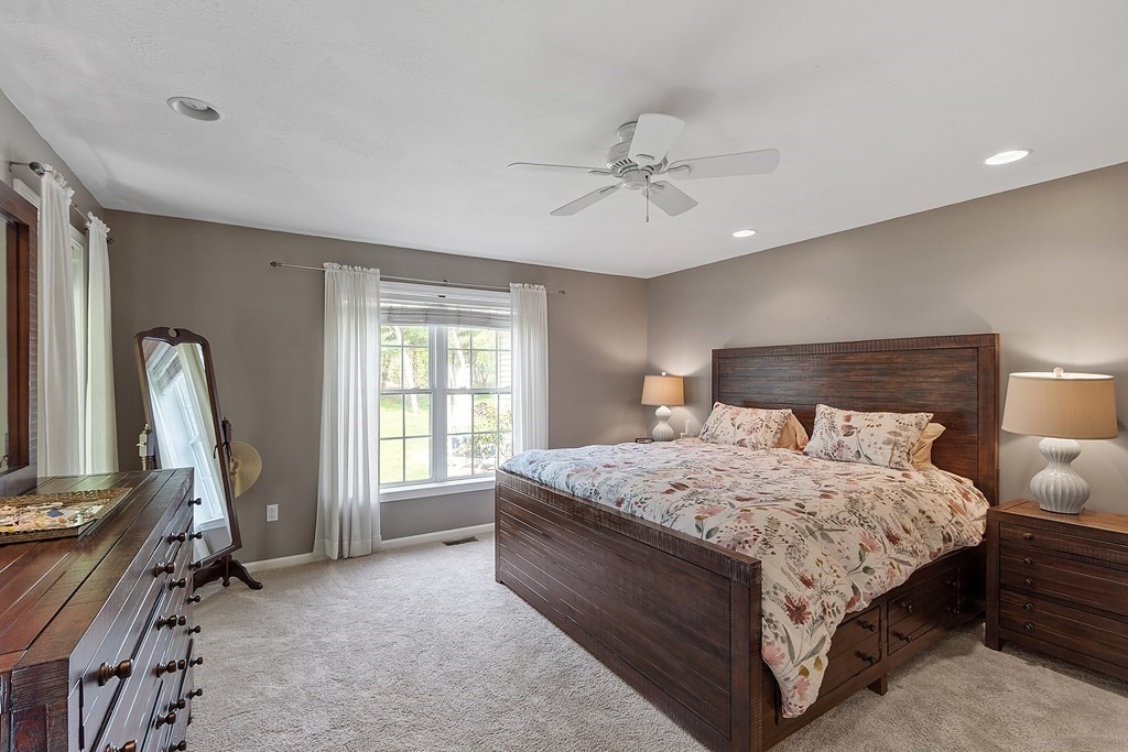 2 Gullane Road Hooksett, NH 03106 - Photo 17 of 27 a bedroom with a bed a chandelier and a window