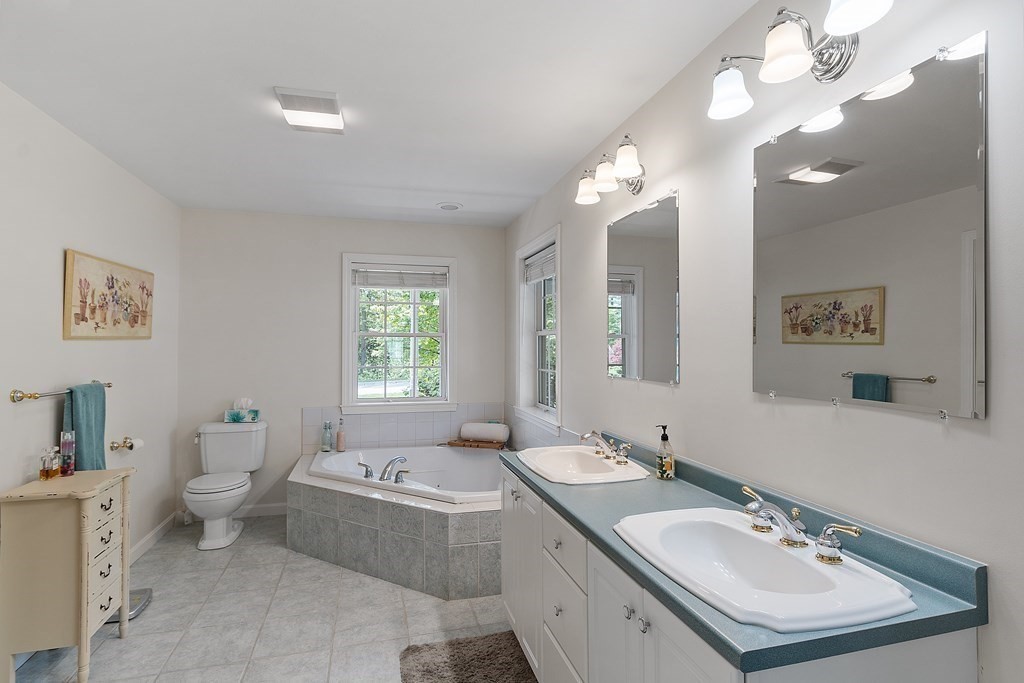 2 Gullane Road Hooksett, NH 03106 - Photo 18 of 27 a bathroom with a granite countertop sink a toilet and a mirror