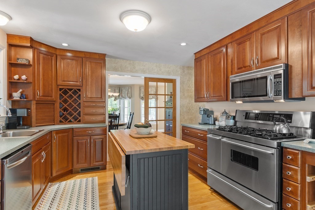2 Gullane Road Hooksett, NH 03106 - Photo 10 of 27 a kitchen with stainless steel appliances granite countertop a stove sink microwave and cabinets