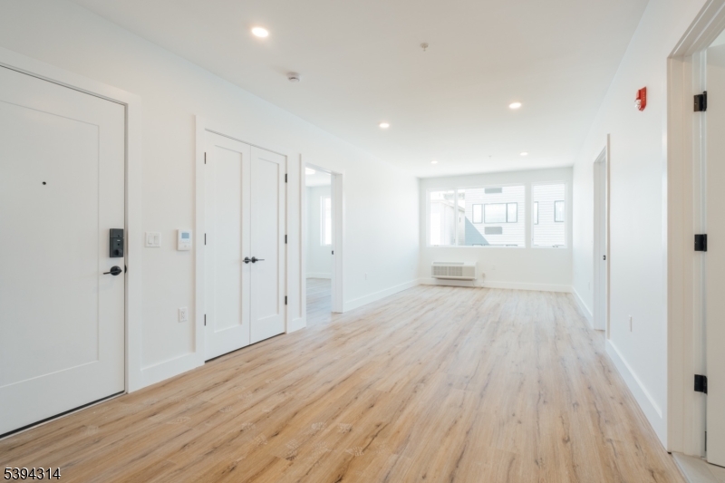 67 Summer Avenue, Unit 202 Newark, NJ 07104 - Photo 16 of 26 a view of an empty room and wooden floor