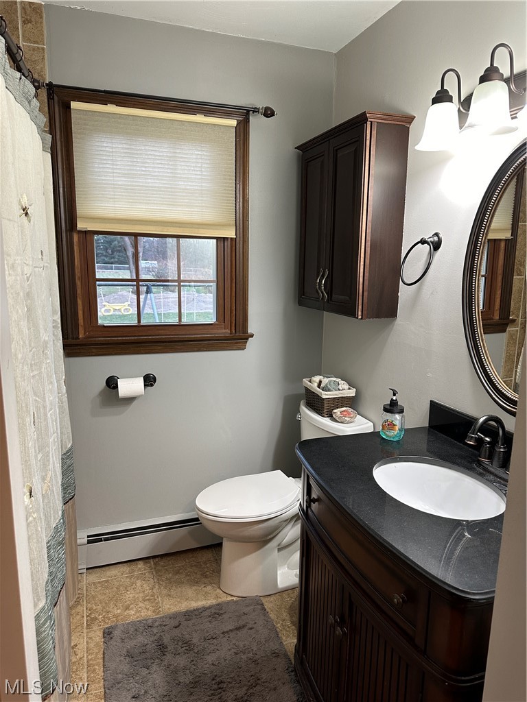 13055 Unity Road New Springfield, OH 44443 - Photo 23 of 49 Bathroom with baseboard heating, toilet, vanity, and tile floors