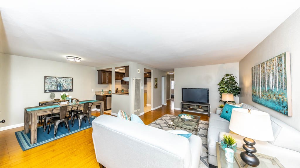 a living room with furniture a flat screen tv and a large window