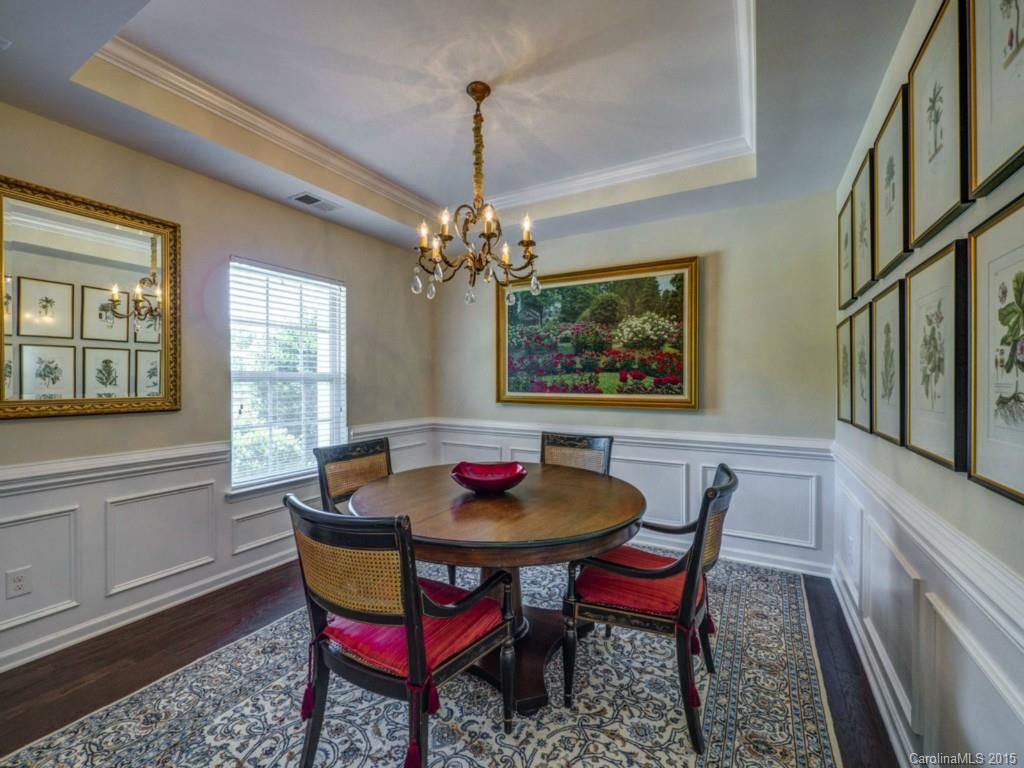 16854 Rudence Court Charlotte, NC 28278 - Photo 2 of 23 a dining room with furniture a rug and a chandelier