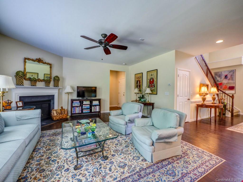 16854 Rudence Court Charlotte, NC 28278 - Photo 6 of 23 a living room with furniture a flat screen tv and a fireplace