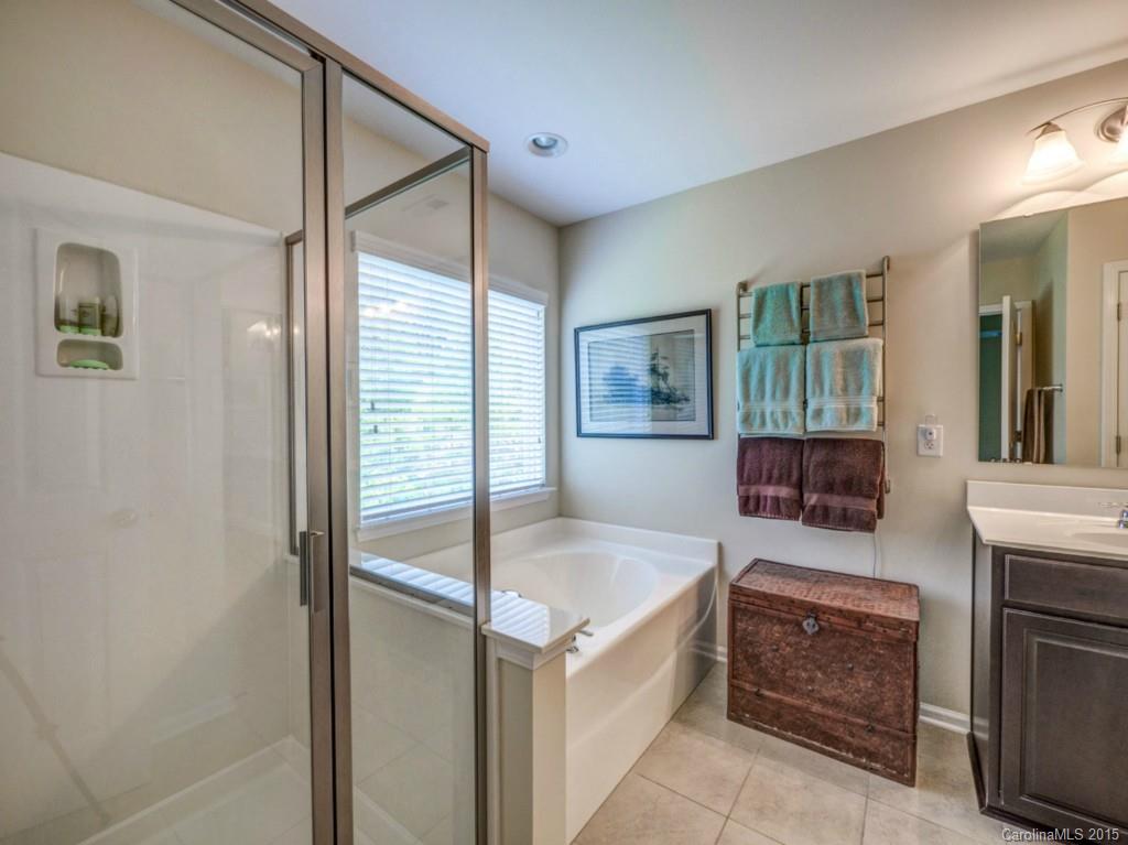 16854 Rudence Court Charlotte, NC 28278 - Photo 10 of 23 a large en suite bathroom with a tub shower and sink