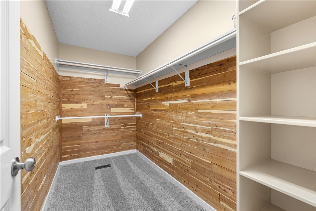 429 Burns Mill Road West Union, SC 29696 - Photo 21 of 49 A well-organized primary closet features cedar plank walls and practical shelving.